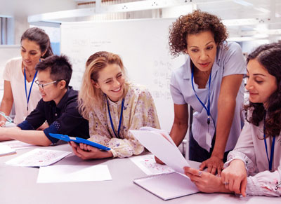 Engineers in an office reviewing notes. Engineers in an office reviewing notes.