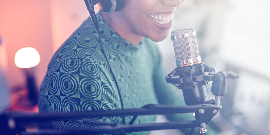 Woman speaking into a microphone.